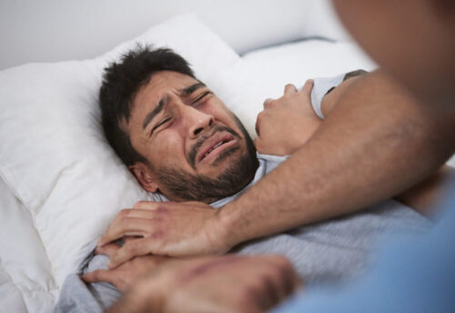 Shot of a young man crying in a mental asylum