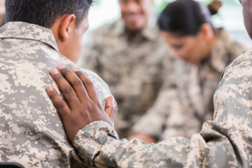 Soldiers pray during therapy session